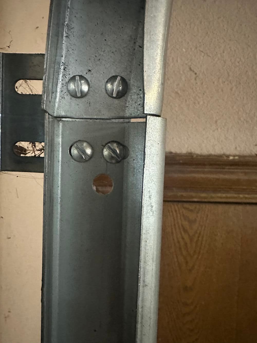 Close-up of a metal bracket with screws, illustrating structural details and assembly.